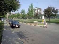 Figure 35. Raised median and pedestrian islands, as illustrated in these two photographs separating multi-lane roads, may provide a measure of safety to pedestrians