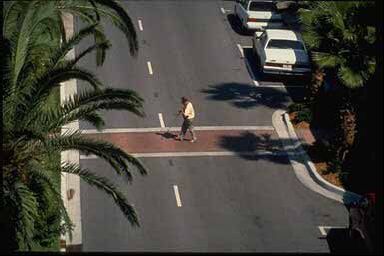 2) This photo shows a two-lane road with a curb extension and a crosswalk with no signal or intersection nearby.