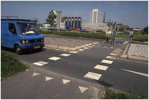 These pavement markings at a median refuge delineate the crossing for motorists and provide visible cues to sighted pedestrians as to the location of the roadway edge.