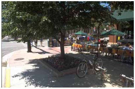 An outdoor cafe can add color and life to a street environment.