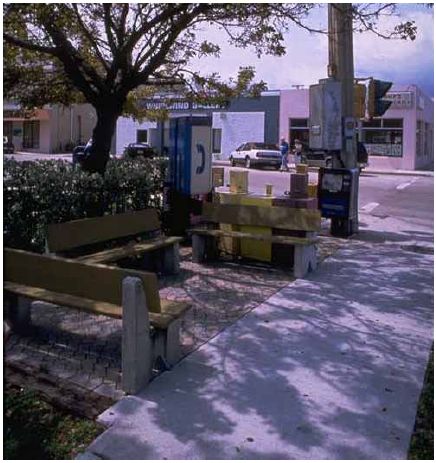 This corner features public telephones and a sitting area that does not encroach on the walkway.