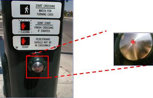 This slide shows two pictures to illustrate an example of an illuminated pushbutton. In the picture on the left, a metal pushbutton is shown below a crossing explanation plaque. The picture on the right shows an enlarged view of the pushbutton, and a small circle is visible in the middle of the metal pushbutton. This small circle is lighted when the pushbutton has been pressed. 