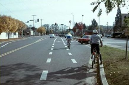The picture shows a bike lane as it approaches an intersection at which a right turn lane is added. The bike lane is dashed in the area in which drivers would merge across the bike lane to enter the right turn lane.