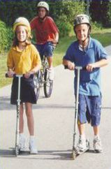 The third picture shows two children on scooters. All the cyclists and scooter riders are wearing helmets.