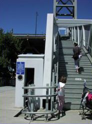 The first picture shows a wheelchair lift for a pedestrian overpass. 