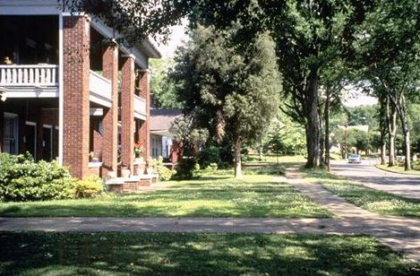 The picture on the right is an interesting street with the trees and shrubs and architecturally interesting homes. Garages and driveways are not prominent.