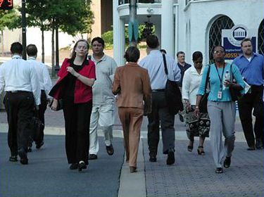 The top picture shows 10 people in a crosswalk, crossing a city street.