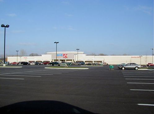 The Picture shows a K-mart store in the distance. The person taking the photo was standing far out in the parking lot, and the photo shows a vast parking lot in the foreground. 