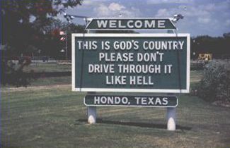 The second picture is of a roadside town marker stating: " WELCOME, THIS IS GOD’S COUNTRY. PLEASE DON’T DRIVE THROUGH IT LIKE HELL. HONDO TEXAS." 