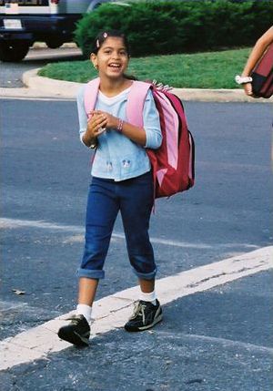 Three pictures are shown. All the pictures are of smiling children crossing at crosswalks.