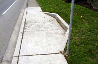 Picture shows a curb ramp at which the sidewalk has been widened to provide a landing of sufficient width. 
