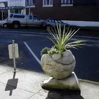 The picture on the right shows a boulder–shaped planter box with landscaping growing from the container.