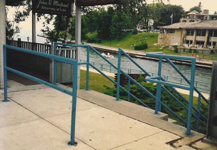 This picture shows the landing at the top of a set of outdoor stairs.