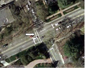 Figure 13. Photograph. Overhead view of pedestrian example intersection (image courtesy of the United States Geological Survey). This is an aerial view of the same intersection as in Figures 11 and 12. In this picture the crosswalk is marked by an arrow pointer.