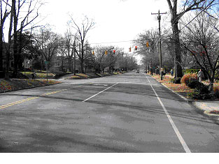 Figure 24. Photograph. Street view of bicycle example 2. This is one of three photographs of the same intersection. This picture, also from the street level, shows the same approach to the intersection along the main road from the east as in Figure 23, but closer to the intersection.