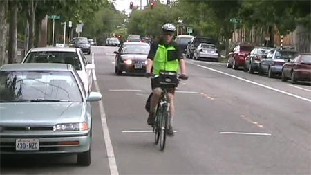 Photo. Typical position of bicyclist after sharrow installation. Click here for more information.