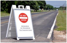 TA public road is closed to outside traffic using a sign that reads "DO NOT ENTER."