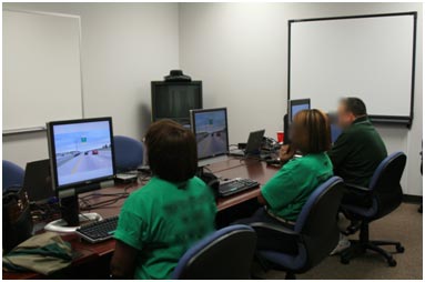 Three study participants take computer-based surveys. They are viewing a roadway scenario on the screen and will be asked to record their opinions.