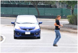 In this example of road user behavior, a pedestrian runs through the crosswalk to avoid an oncoming motor vehicle.