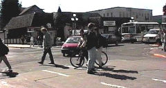 Pedestrians and bicycles causing delay to turning vehicles in Eugene, Oregon.