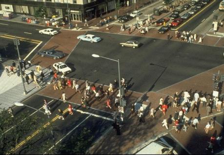 Aerial view of intersection with many pedestrians crossing