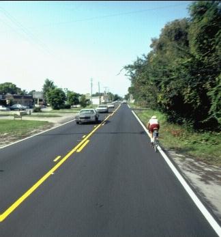 a photo of a bicyclists on a roadway