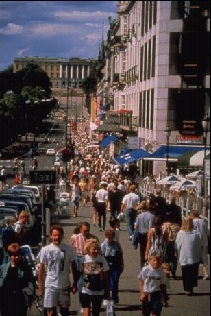 A crowded sidewalk in a urban area