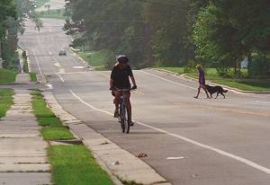 Picture of woman riding bike on street.