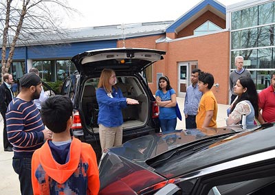 TFHRC Transportation Research Engineer Deb Curtis talks about connected vehicle technology with a group of students.