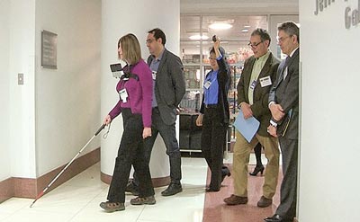 Barbara Campbell, a visually-impaired test subject, uses ISANA technology to navigate to the eighth floor in USDOT headquarters.