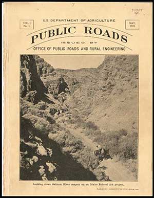 This image shows the cover of Public Roads magazine from May 1918. The cover’s text reads, “Volume 1, No. 1, U.S. Department of Agriculture Public Roads Issued by Office of Public Roads and Rural Engineering May 1918” Below the text there is a black and white image of a dirt road through a canyon. Two men are each riding a horse on the dirt road.
