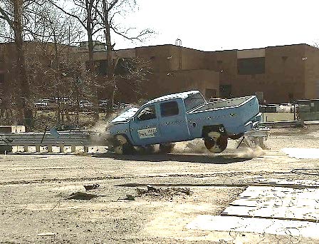 A pickup truck crashes into a bridge-end barrier at the FOIL crash test facility in McLean, VA.