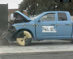 This is a photograph taken from a video recording of the moment a truck crashes into a wall.