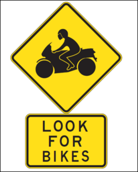 A sample of a diamond-shaped highway sign that shows an icon of a person on a motorcycle. Beneath the diamond-shaped sign is a square-shaped sign that reads Look For Bikes.