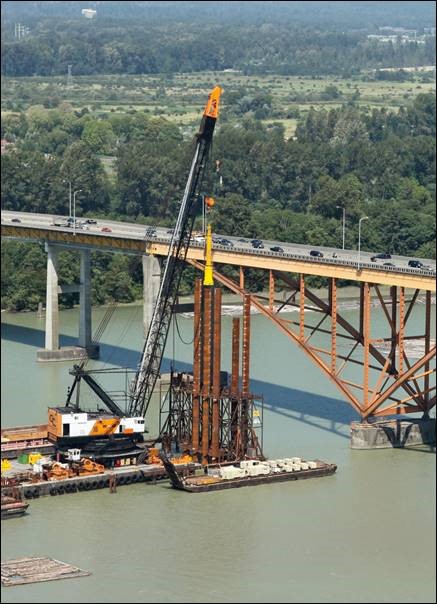 Large diameter open-end steel pipe piles are being installed to support the bridge.