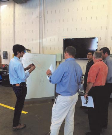 Drivers review the appropriate vehicle formation for collecting data for a speed harmonization test drive. Test drives involve three equipped vehicles and up to three probe vehicles.