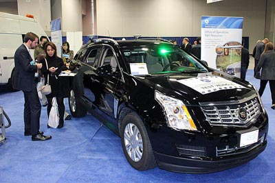 Photo of FHWA’s Taylor Lochrane at the Office of Operations R&D exhibit hall display at the TRB Annual Meeting, which showcased one of FHWA’s connected automation test vehicles. 