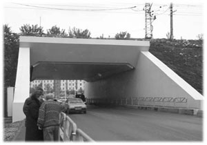 Car tunnel below a rail line