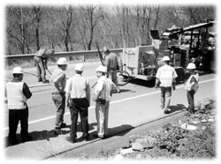 Photo of Nizhny Novgorod delegation observing crack-sealing equipment in operation