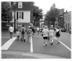 Photo of pedestrians walking in a crosswalk across an intersection