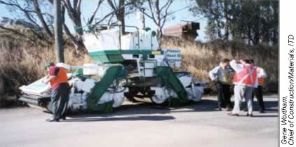 The Hot Iron Principle Asphalt Compactor shown here uses a rubber belt wrapped around steel rollers to ensure even compaction and ultimately to reduce cracking in completed roadways.Gene Wortham, Chief of Construction/Materials, ITD