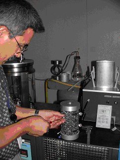 An expert from FHWA’s mobile asphalt laboratory performs QA testing on a specimen.