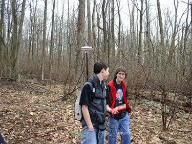 Two students use an NDGPS device to plot the location of a hiking trail near ThorpeWood, an environmental education center in Thurmont, MD.