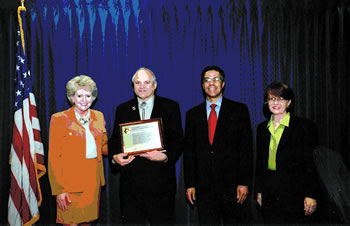 Wes Goff, the winner of the Environmental Leadership Award to an individual, poses for a photo. Left to Right: Mary Peters, FHWA Administrator; Wes Goff, Colorado Department of Transportation; Dr. Dale Jones, legislative director for Colorado Congressman Bob Beauprez; Cindy Burbank, Associate Administrator for Planning, Environment, and Realty.