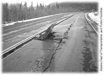A piece of asphalt buckles cracked section of the Tok Cutoff Highway