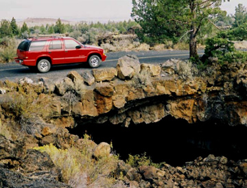 Vehicle driving over a lava tube known as Bear Paw Bridge