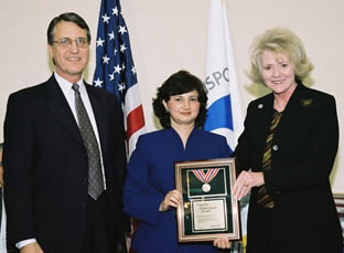 FHWA Administrator Mary E. Peters and Associate Administrator for Research, Development and Technology Dennis Judycki, director of the TFHRC, present an Administrator's Awards to Sheila Duwadi 