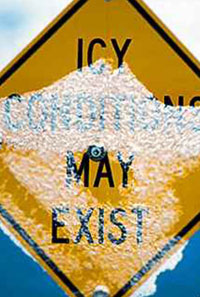 a snow covered Icy Conditions May Exist warning sign
