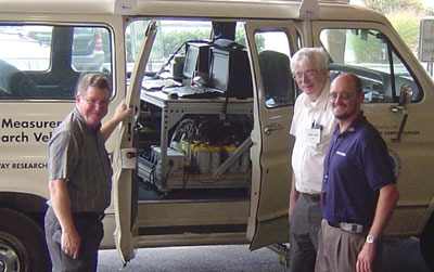 Jim Mekemson, Pete Mills, and Brian Schleppi, participants in the recent technology transfer workshop hosted by the FHWA Resource Center Pavement and Materials Team, stand beside the Digital Highway Measurement Vehicle.