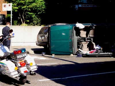 A member of a law enforcement agency collects data at the scene of an incident. The 2005 traffic records forum will promote improvements in the collection of this type of data.